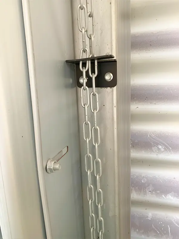 Close-up of the manual chain hoist mechanism for emergency sectional door operation during power outages.