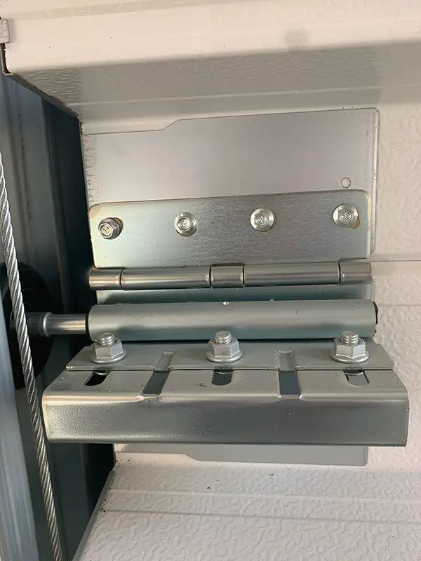 Heavy-duty galvanized steel side hinge and roller bracket installed on the sectional sectional door panel.